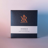 Luxury packaging for niche perfume Hide by Redolescent. Glittering blue box with embossed logo with a misty blue belly band across the lower middle.